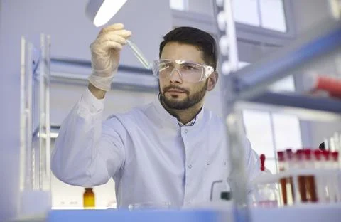 Young man assistant do experiments in lab Stock Photos