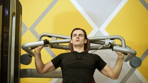 The young man of athletic build doing fitness training on exercise equipment. HD Stock-Footage 73120235