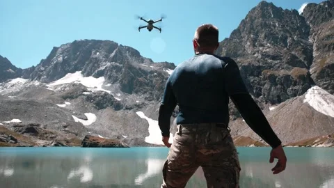 A young man with an athletic physique launches a drone from his hands Stock Footage 138444795