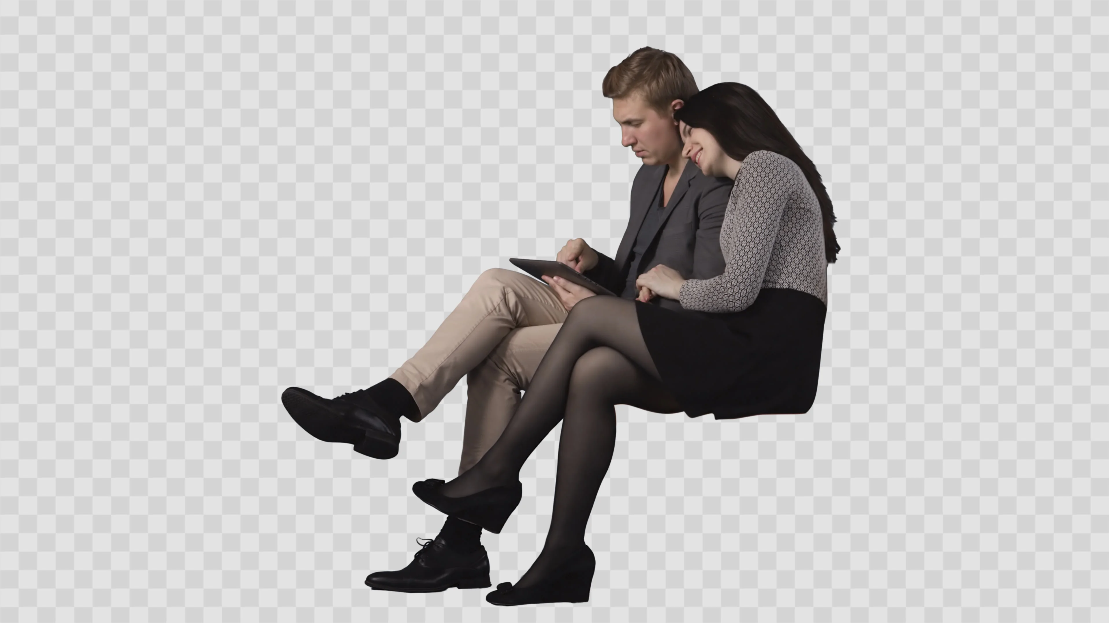 Young man and attractive brunette girl are sitting together and reading PC tablet