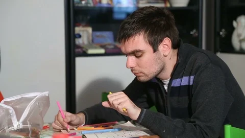 Young man with autism drawing Stock Footage 85577222