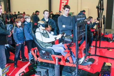 The young man in the auto-simulator. Stock Photos