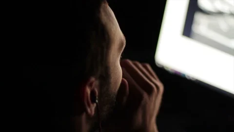 Young Man Back light Looks At Monitor Stock Footage 75277052