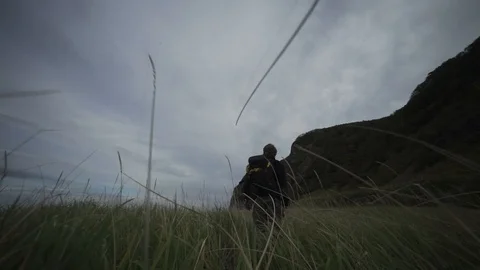 Young man with backback in the field Stock Footage 101509796