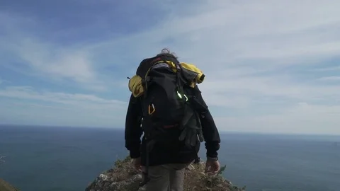 Young man with backback on the mountain Stock Footage 101509656