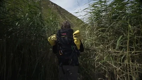 Young man with backback on the mountain Stock Footage 101509791