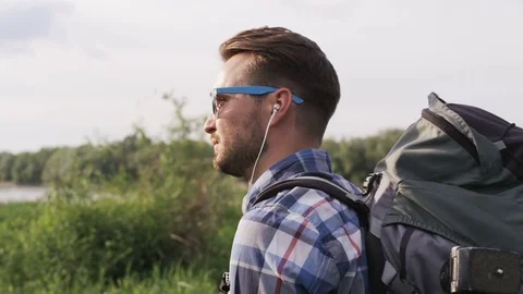Young Man With a Backback Standing and Looking Up Stock Footage 77678789