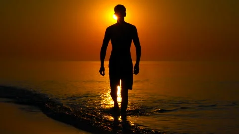 Young man on the background of the sea sunset Stock Footage 135319784