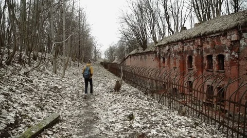 A young man With backpack on back walks through the park in the spring or autumn Stock Footage 74110075