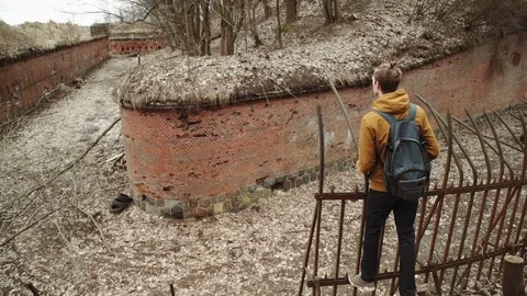 A young man With backpack on back walks through the park in the spring or autumn Stock Footage 74110530