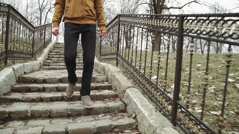 A young man With backpack on back walks through the park in the spring or autumn Stock Footage 74148860
