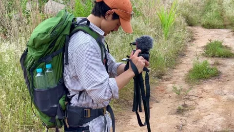 Young man with backpack hiker recording vlog Stock Footage 194482995