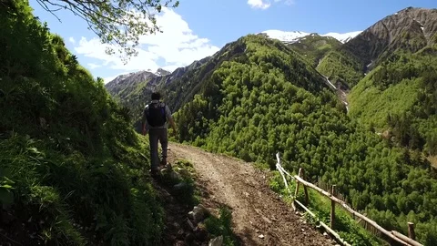 Young man with a backpack hiking in the mountains of Geogia. Stock Footage 86697159