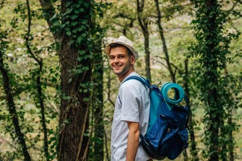 Young man with backpack in nature Stock Photos