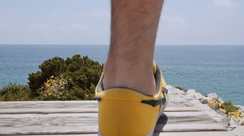 Young man with backpack run to the edge and looks at the stunning views Stock Footage 64960322