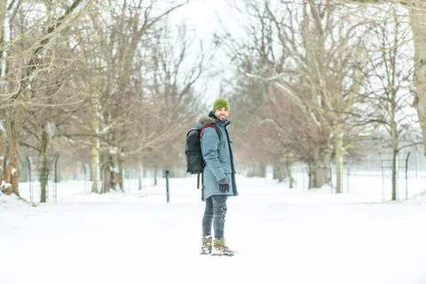 Young man with backpack on the snow. Stock Photos