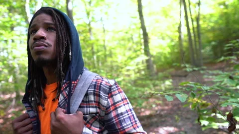 Young Man With Backpack Standing Surrounded by Trees and Plants Stock Footage 142016901