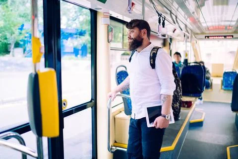 Young man with backpack waiting for bus stop Stock Photos