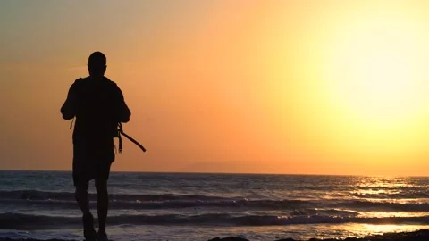Young man with backpack walking on beach during summer vacation Video stock 133376195