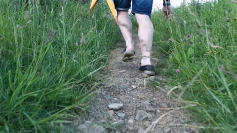 Young man with backpack walking on paths Stock Footage 130854650