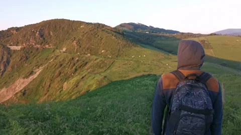 Young man with backpack walking on paths Stock Footage 130854770