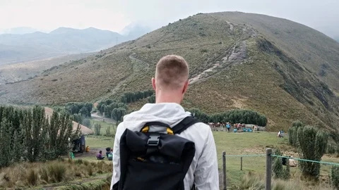 Young man with backpack walking on trail in mountains near Quito, Ecuador Video stock 128156556