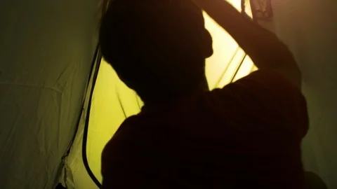 Young man backpacker exits camping tent in front of roman aqueduct arches in 스톡 동영상 91085694