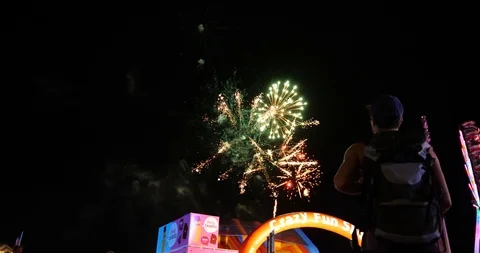 Young man backpacker watching fireworks at the show/fair Stock Footage 104253864