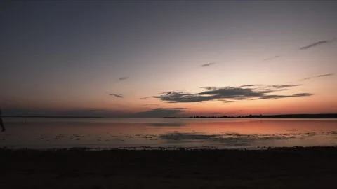 Young man with bag walking in sunset beach with panorama Stock Footage 95176545