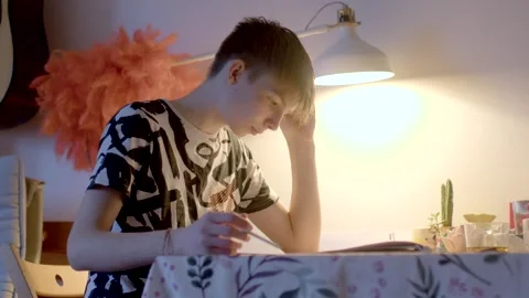 A young man balances studying and working from home, facing stress Stock Footage 311205943