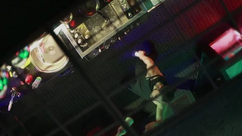 The young man, bartender juggling bottles on a black background. Stock Footage 103382297