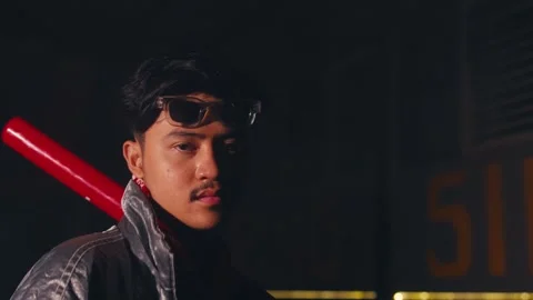 Young Man with Baseball Bat in Dramatic Lighting Stock Footage 303524091