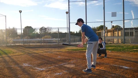 A young man baseball player not swinging at a ball from the pitcher over Stock Footage 100689108