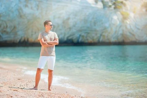 Young man on the beach having fun Stock Photos