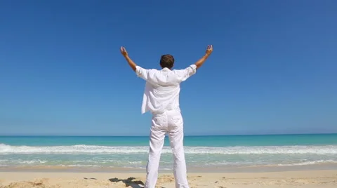 Young man on beach hold hands arms up Vacation concept of freedom travel Stock Footage 62906828