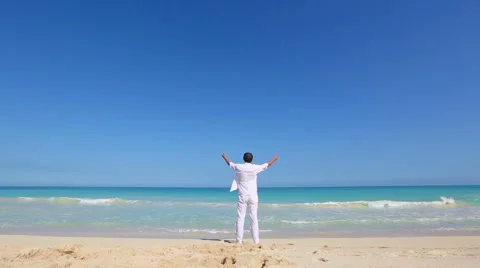 Young man on beach hold hands arms up Vacation concept of freedom travel Stock Footage 62907248