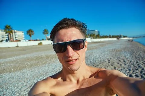 Young man on the beach Stock Photos