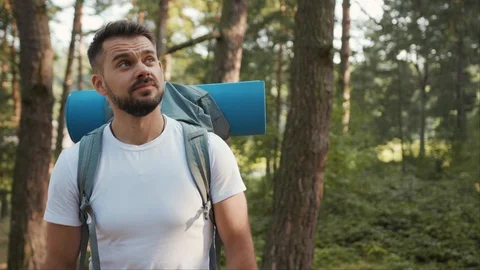 Young Man with beard and backpack use phone around blue animation сloud Stock Footage 126789388