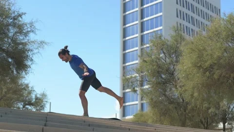Young man with beard and ponytail performing stretching exercises in an urb.. Stock Footage 229727762