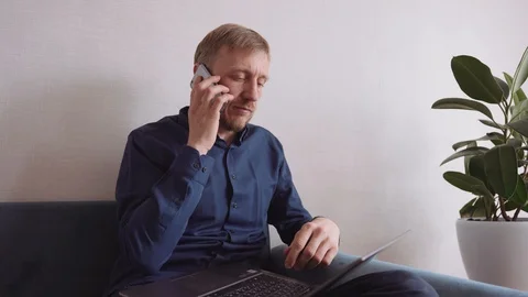Young man with a beard calls on a mobile phone Stock Footage 128303888