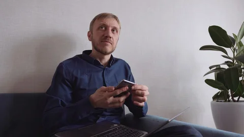 Young man with a beard calls on a mobile phone Stock Footage 128303998