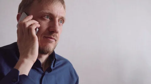 Young man with a beard calls on a mobile phone Stock Footage 128304264