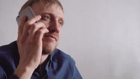 Young man with a beard calls on a mobile phone Stock-Footage 128304801