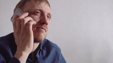 Young man with a beard calls on a mobile phone Video stock 128304907