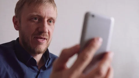 Young man with a beard communicates by video link Stock Footage 128298835