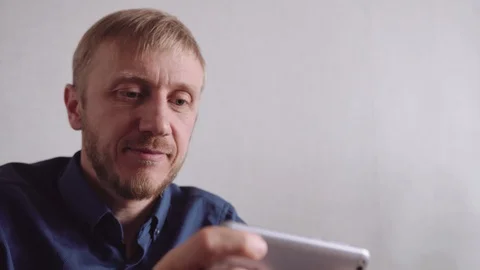 Young man with a beard communicates by video link Stock Footage 128298873