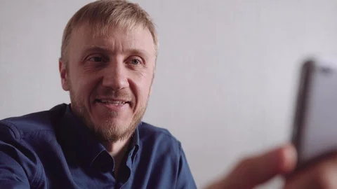 Young man with a beard communicates by video link Stock Footage 128299185