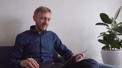 Young man with a beard communicates by video link Stock Footage 128301733