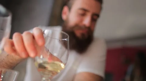 Young man with a beard drinking a glass of white wine Stock Footage 61513790