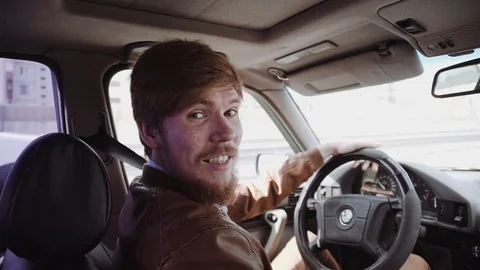 Young man with beard driving a car. Inside shot Stock Footage 75714995